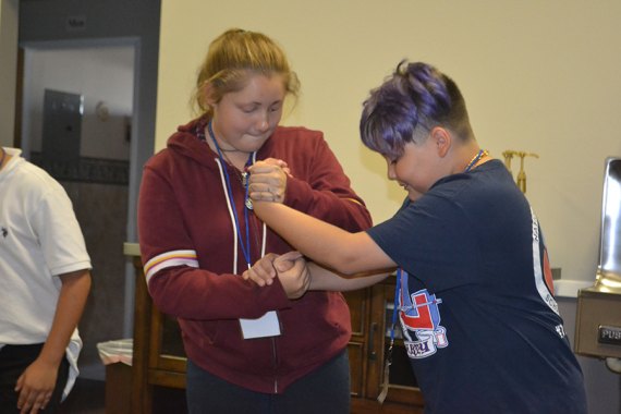 Lindsay Reynolds (left) and Angel Aguirre take part in an exercise during Monday's LASSO session in the Lemoore Presbyterian Church Fellowship Hall.